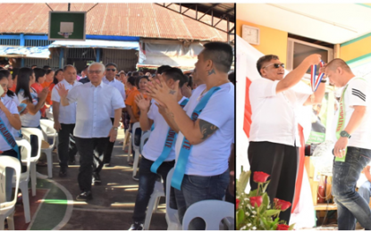 <p><strong>HOPE AFTER PRISON</strong>. Batangas Governor Hermilando Mandanas (left) graces the first joint graduation rites of some 30 inmate-completers for the Department of Education's Junior High School-Alternative Learning System (ALS) and 99 graduates of the Technical Education and Skills Development Authority's Health and Wellness Massage Training course at the Batangas Provincal Jail covered court in Batangas City on Tuesday (May 29, 2018). Provincial Warden Jail Senior Supt. Chito Malapitan (right) puts on the medal to an inmate-achiever in the Junior High School-ALS program.<em> (Photo courtesy of Batangas Capitol PIO)</em></p>